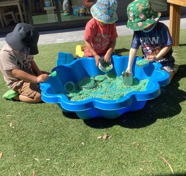 Children at water play in the outdoor yard at Romsey Early Learning